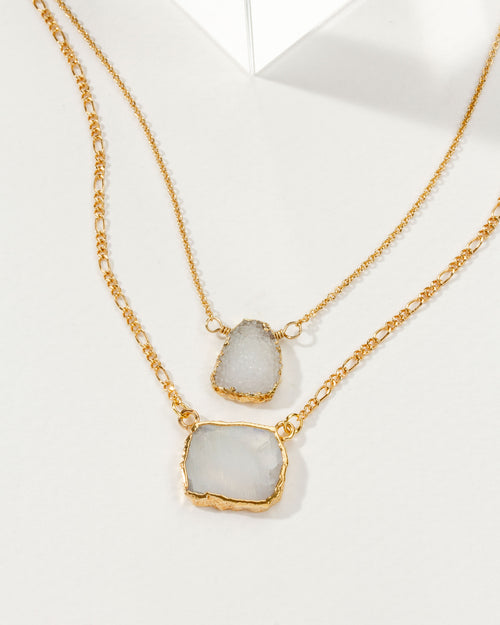 Layered necklace with gold chains and rainbow moonstone & druzy pendants.