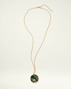 Gold chain necklace with a round Moss Agate medallion pendant.