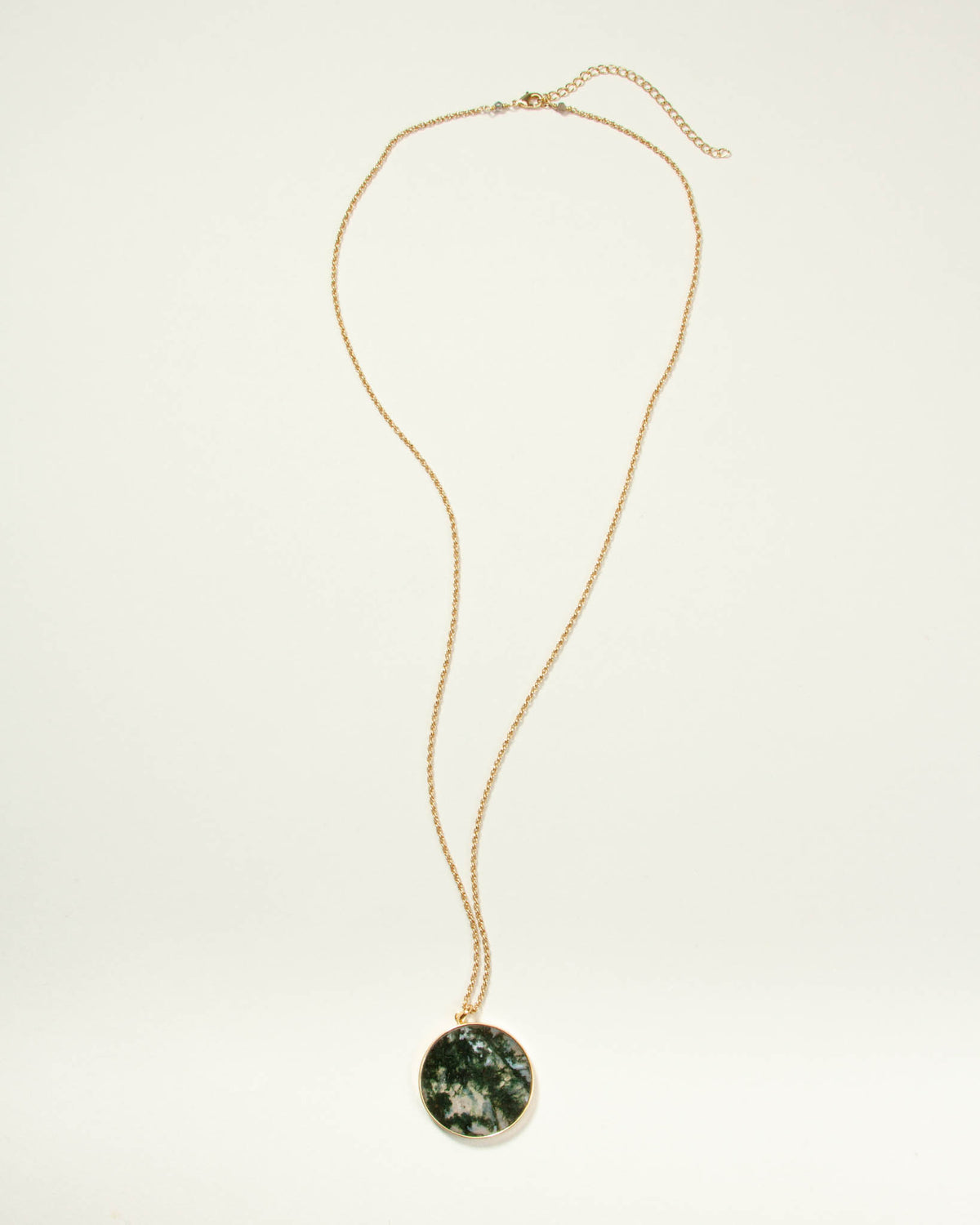 Gold chain necklace with a round Moss Agate medallion pendant.