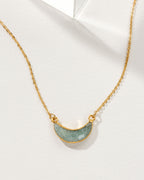 Eclipse Necklace with an Aquamarine crescent moon pendant and gold chain.