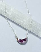 Eclipse Necklace with a silver chain and amethyst gemstone crescent moon pendant.
