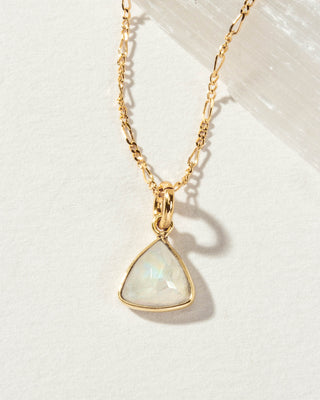 Close up of Moonstone Bermuda Triangle Dainty Collar Necklace with a 14 Karat Gold Plated Brass chain laying on a white background.