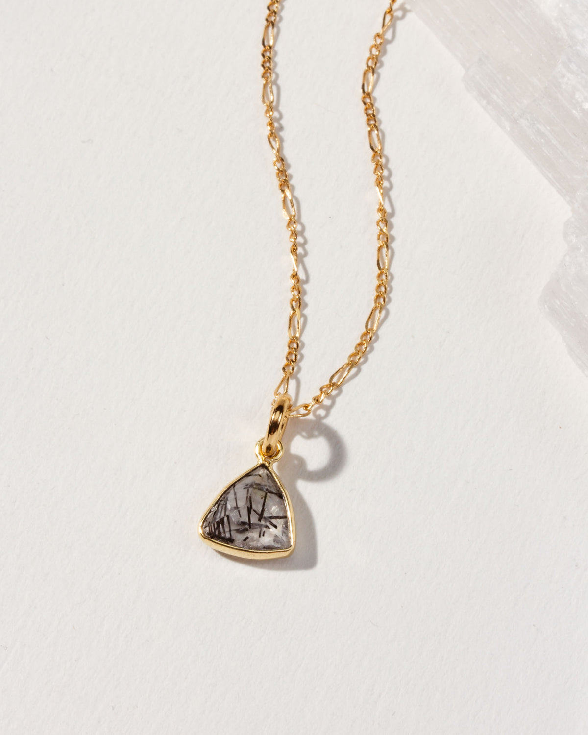 Detail of triangular tourmalinated quartz pendant necklace