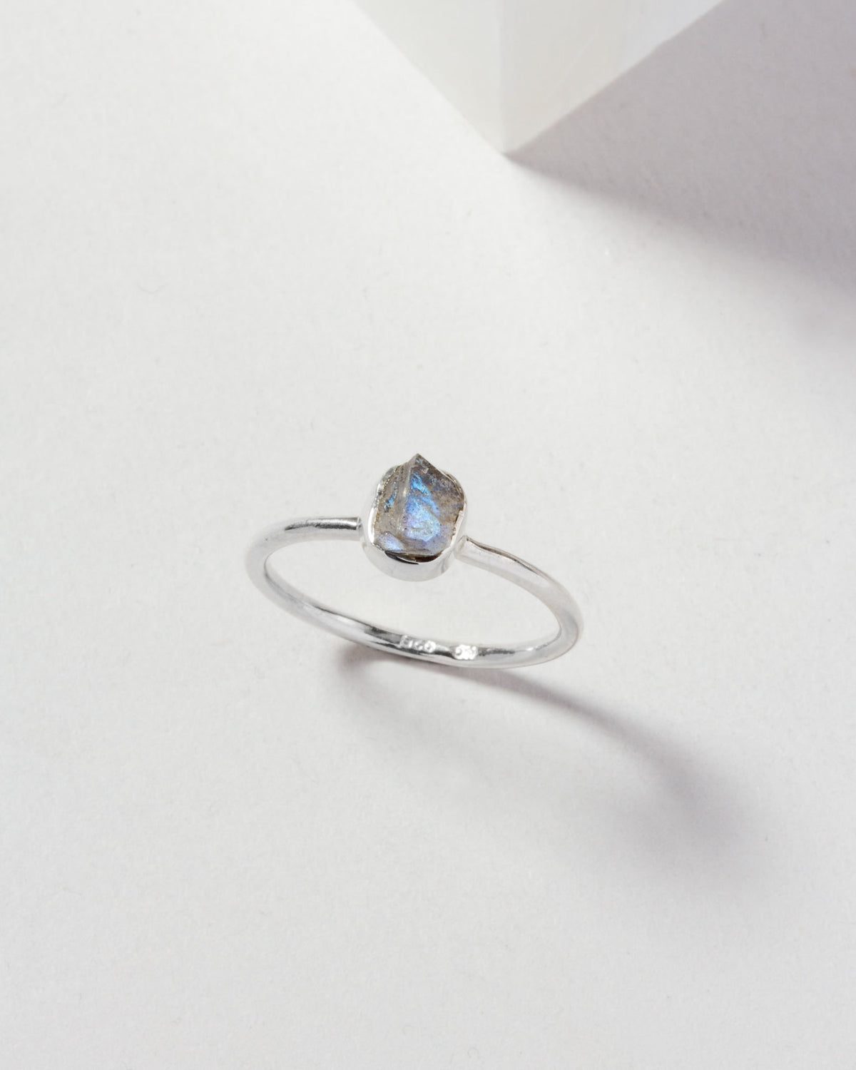 Silver ring with a blue labradorite gemstone.