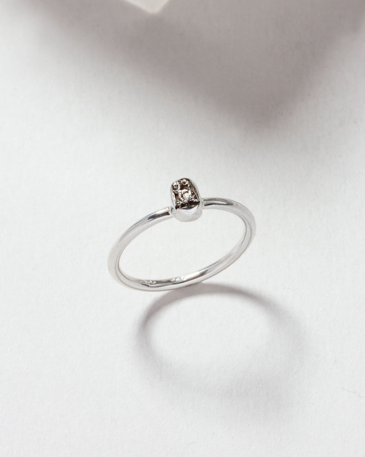 Silver ring featuring a genuine meteorite stone detail.