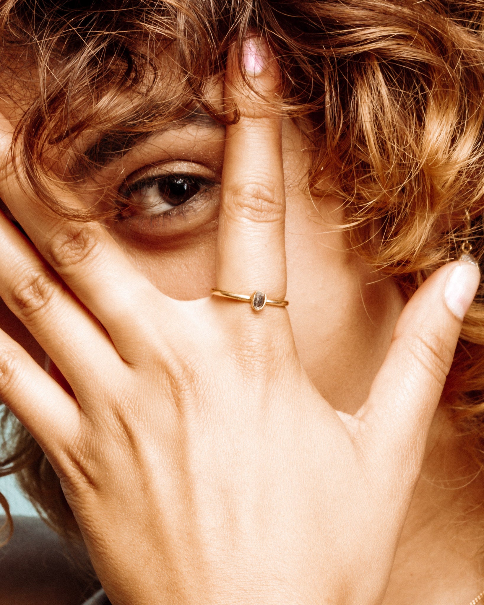 Close-up of a hand with a 14k Gold Plated Herkimer Quartz ring on the index finger.