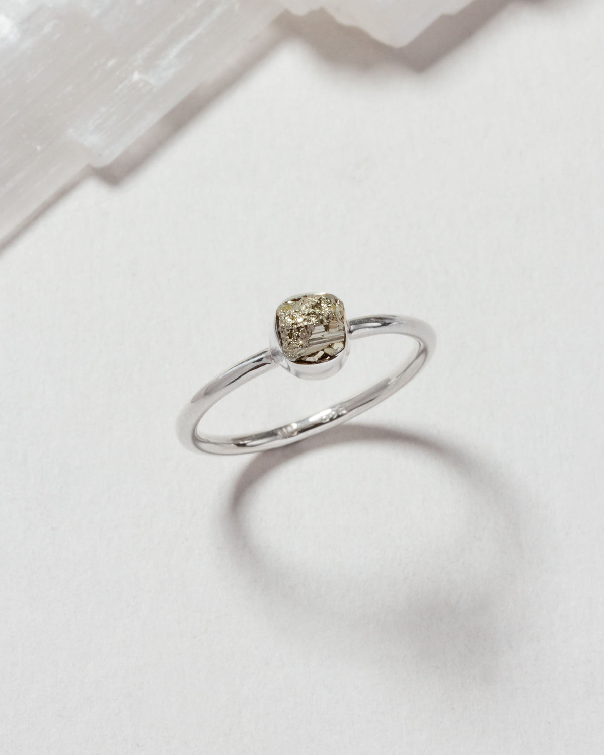 Silver ring featuring a square pyrite stone.