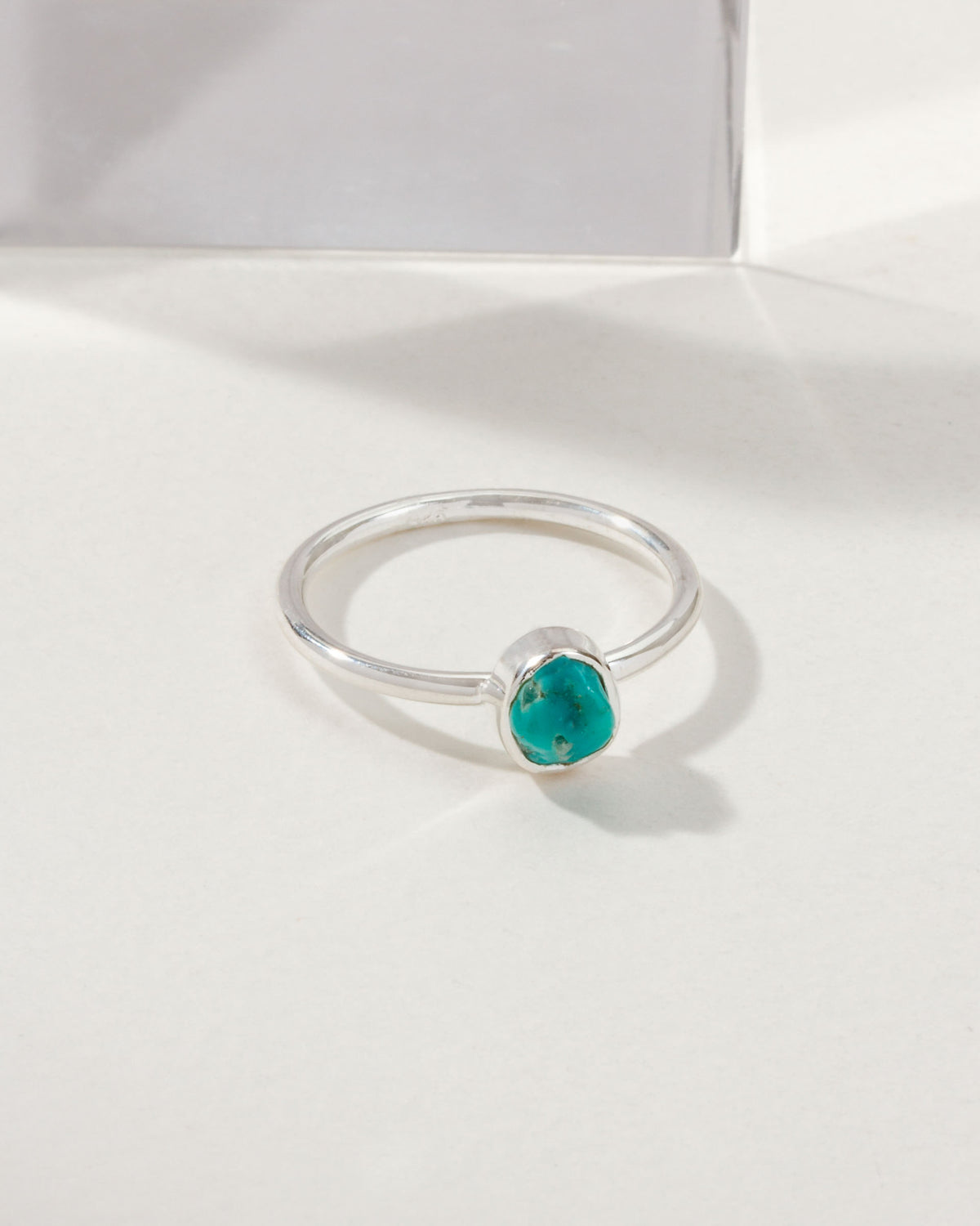 Sterling silver ring featuring a rough-cut turquoise stone.