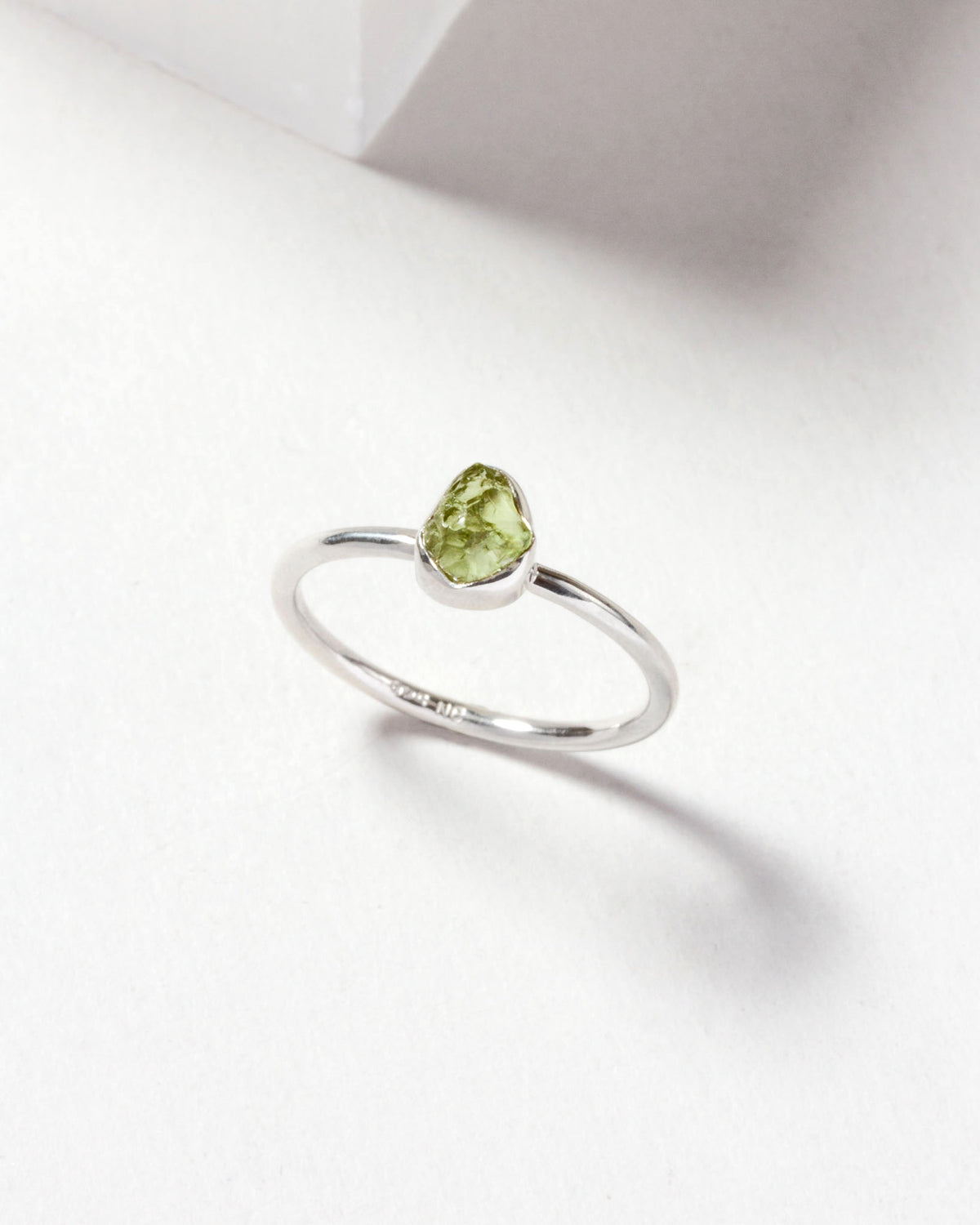 Sterling silver ring with a raw cut peridot gemstone.