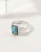 Silver ring featuring a square, blue labradorite stone.
