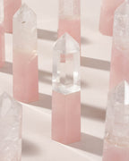 Rose Quartz and Clear Quartz crystal towers are displayed on a light surface.