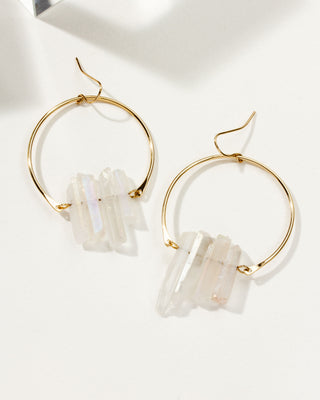 Mystic Clear Supernova Hoop earrings on a white table.