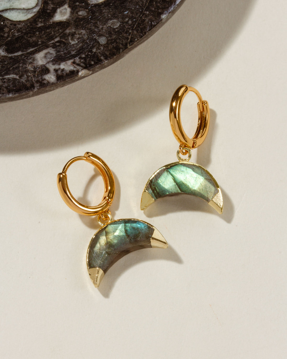 Crescent Horn Huggie Hoop Earrings with Labradorite gemstones and gold hoops.