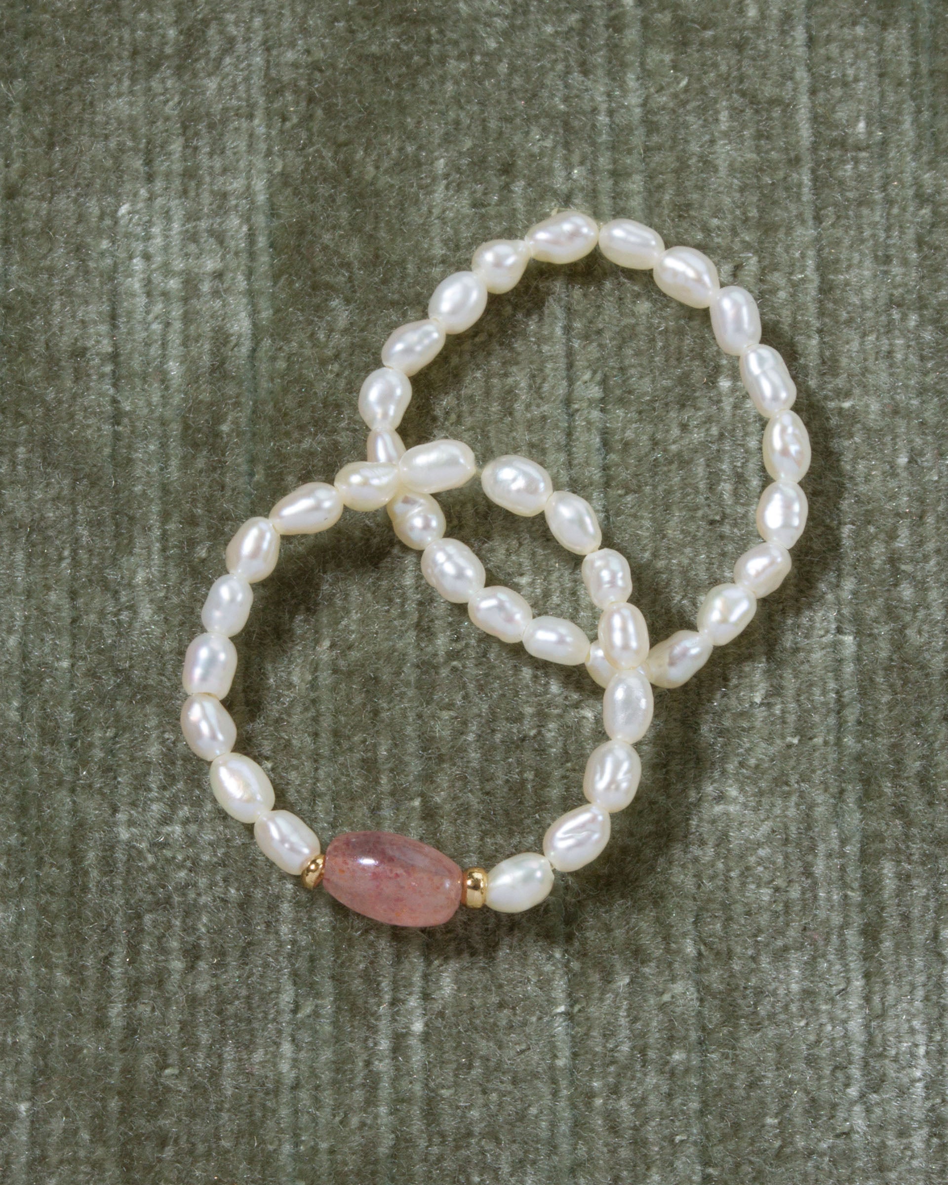 Two Coastal Stretch Rings: one with Freshwater Pearls and one with Strawberry Quartz.
