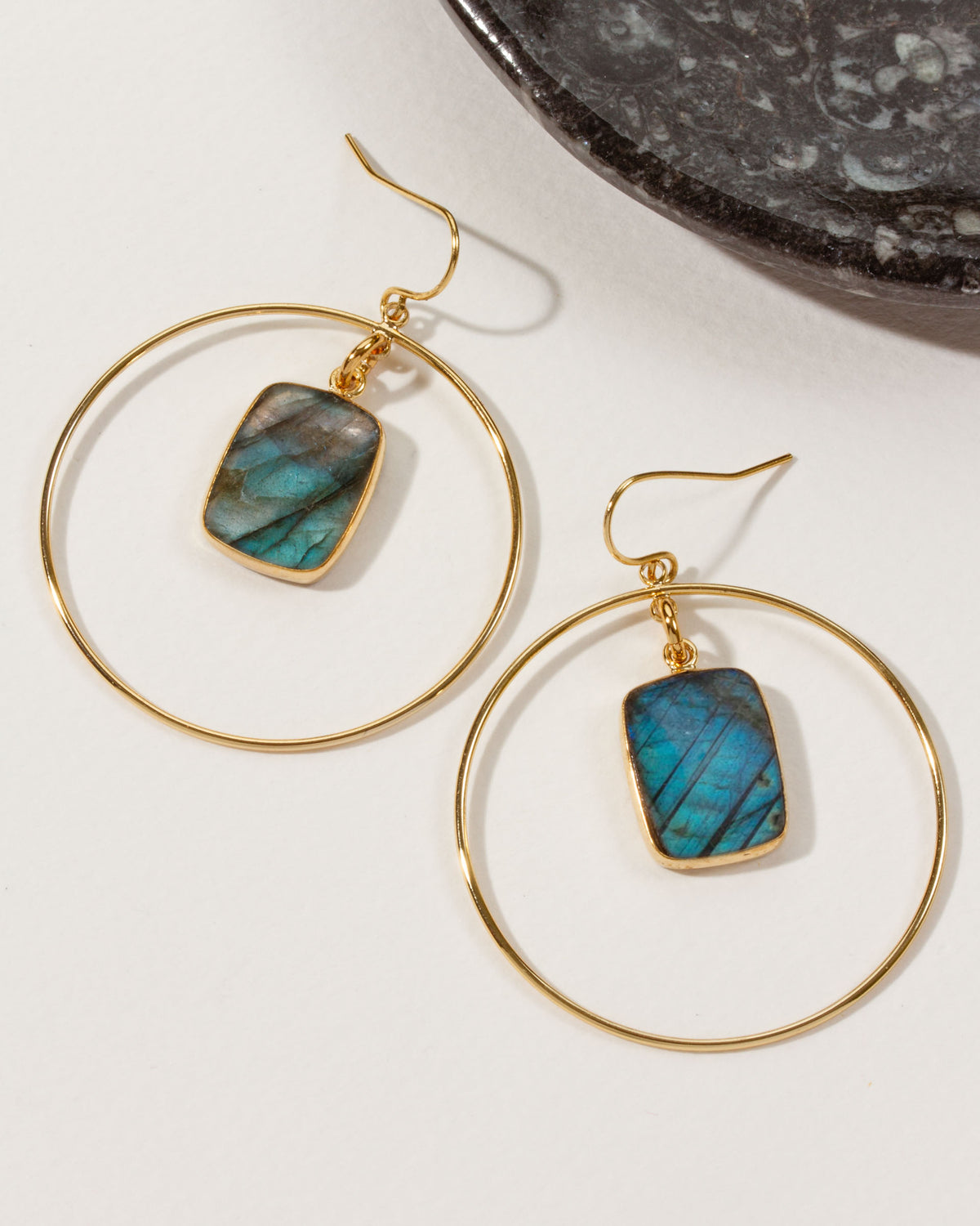 Two Stoney Hoop Earrings with gold hoops and labradorite gemstones.