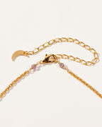 Strawberry Moon Medallion Necklace's gold chain, clasp, and small, round, pink stones.