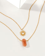 Sun Salutation Necklace Set with a sun charm and a Sunstone gemstone on gold chains.