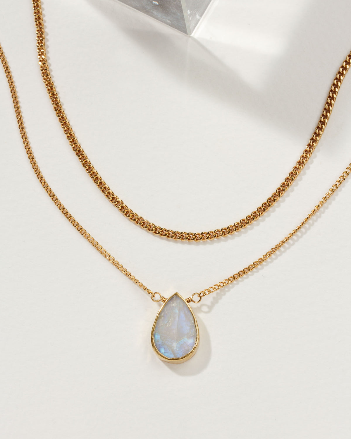 Daily Necklace Set with gold chains and a Moonstone pendant.