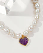 Pearl necklace with an amethyst heart-shaped pendant.