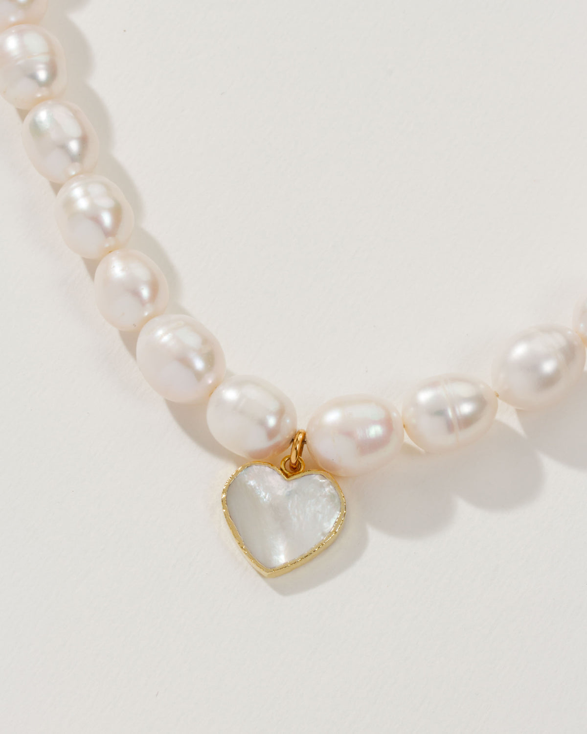 Necklace with baroque pearls and a Mother of Pearl heart pendant.