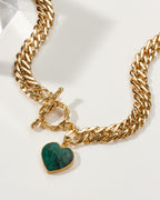Gold chain Heart of Gold Toggle Necklace with green heart-shaped stone.