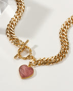Gold chain necklace with toggle clasp and strawberry quartz heart pendant.