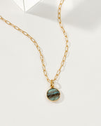 Ellipsis necklace with a gold chain and a Labradorite gemstone pendant.
