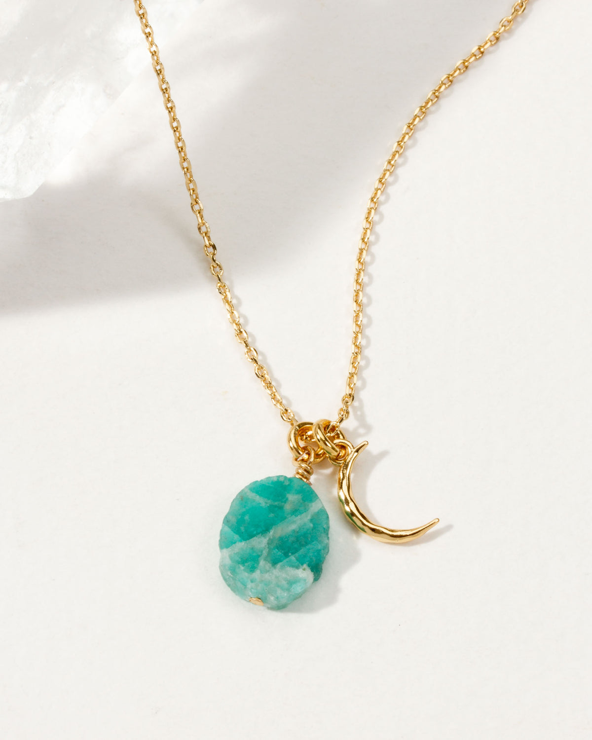 Gold necklace with crescent moon and Amazonite gemstone.