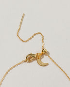 Close-up of the Celestial Being necklace clasp and adjustable chain, with tiny crescent moon detail.