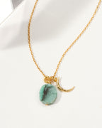 Gold chain necklace with crescent moon charm and green Emerald gemstone.