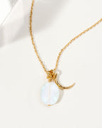 Gold necklace featuring a crescent moon charm and a Moonstone gemstone.