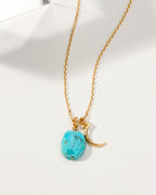 Gold Celestial Being birthstone necklace with a Turquoise gemstone and crescent moon charm.