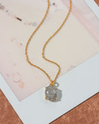 Gold chain necklace with an oval Tourmalinated Quartz pendant.