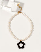 Oops-A-Daisy necklace with pearl beads and an Onyx flower pendant.