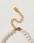 Close-up of the Oops-A-Daisy necklace clasp and extender chain, featuring white pearls.