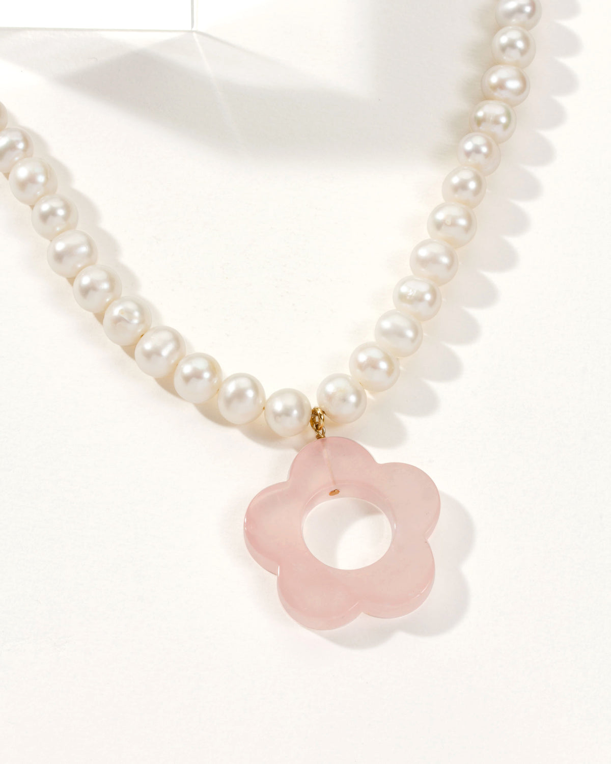 Oops-A-Daisy Necklace with a pearl chain and a Rose Quartz flower pendant.