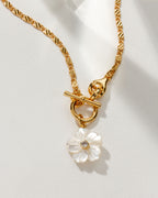 Gold chain necklace featuring a mother of pearl flower pendant with a CZ center.