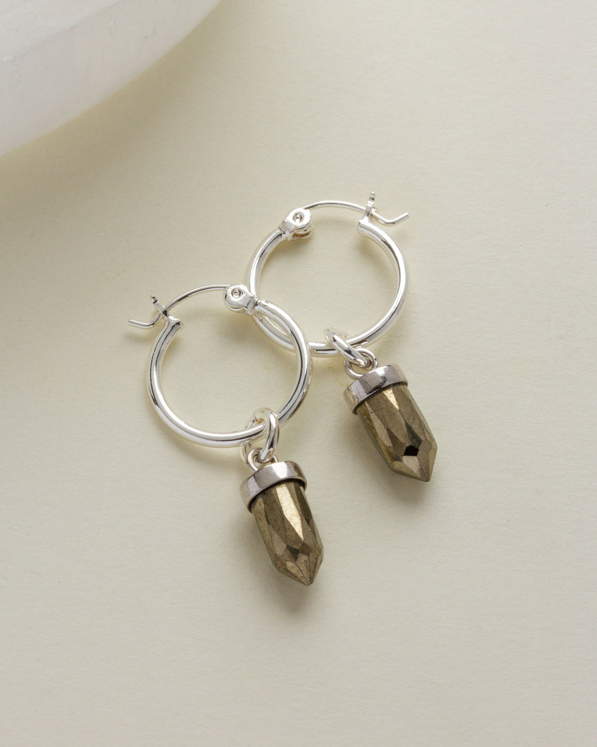 Silver "On Point Mini Hoops" earrings with dangling Pyrite stone pendants.