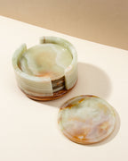 Round calcite stone coasters in a matching stone holder