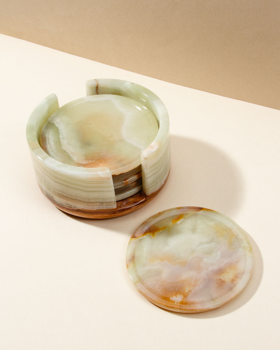 Round calcite stone coasters in a matching stone holder