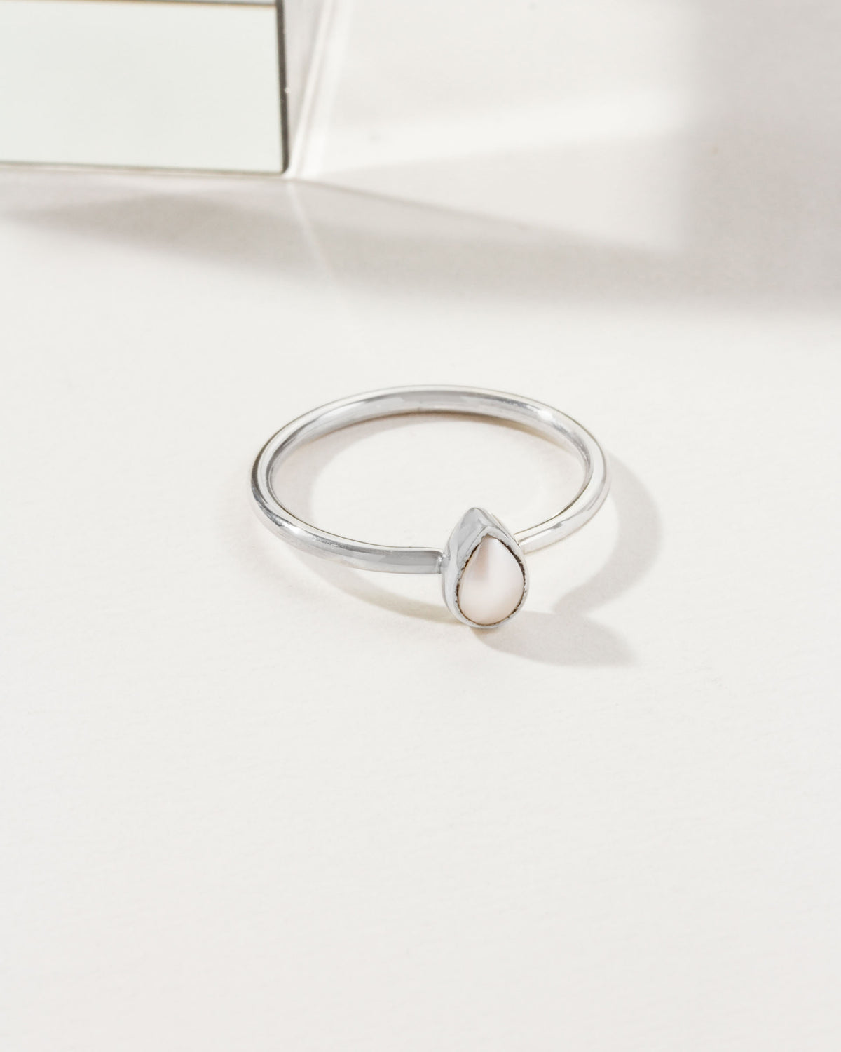 Silver ring with a teardrop freshwater pearl.