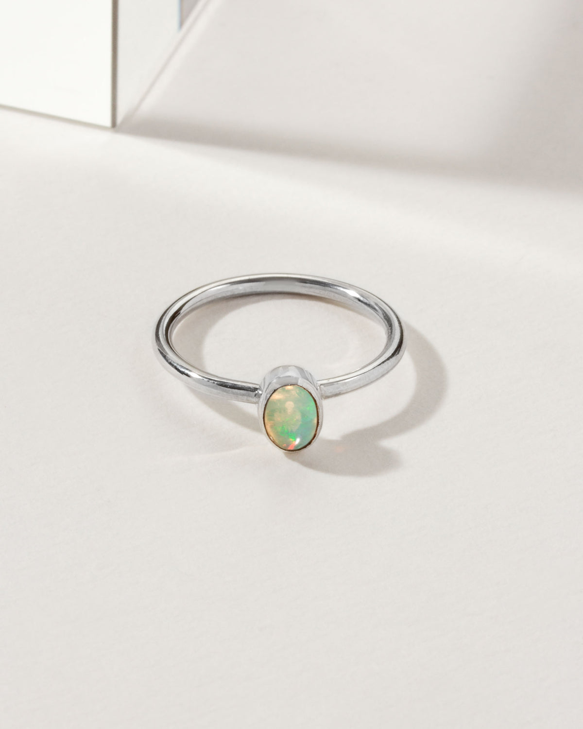 Sterling silver ring with an oval, Play of Color Opal gemstone.