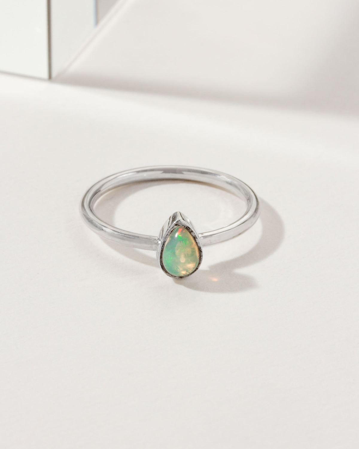 Sterling silver ring with a teardrop opal gemstone.