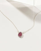 Silver plated brass necklace with a teardrop ruby gemstone pendant.