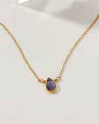 Gold necklace with a teardrop-shaped Tanzanite gemstone pendant.
