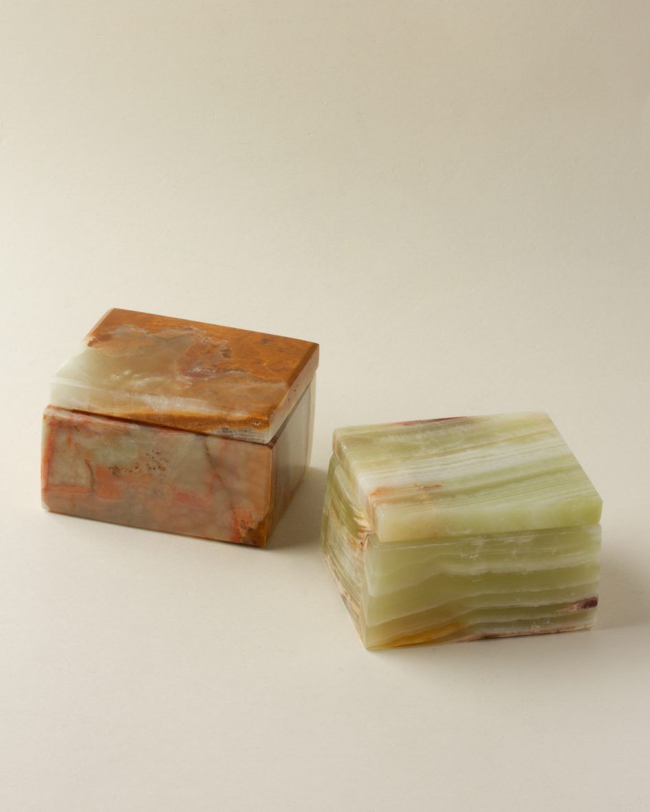 Two calcite jewelry boxes: one brown and one green.