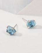 Aquamarine Raw Beauty Birthstone Post Earrings on a white tabletop