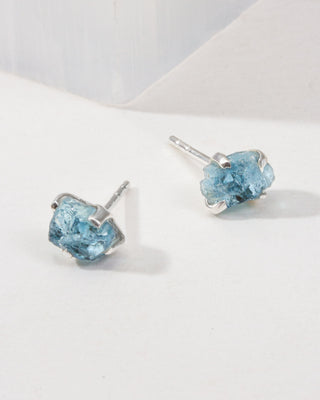 Aquamarine Raw Beauty Birthstone Post Earrings on a white tabletop