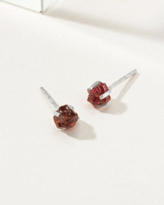 Garnet Raw Beauty Birthstone Post Earrings on a white tabletop