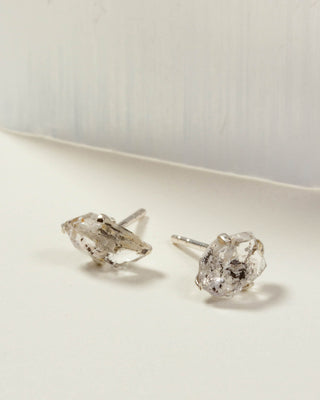 Herkimer Quartz Raw Beauty Birthstone Post Earrings on a white tabletop